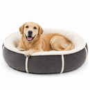 A golden retriever dog lies inside a round pet bed with a dark gray exterior, cream sherpa lining, and white stitched trim, photographed on a clean white background.

