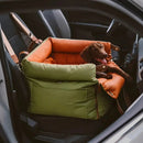 DreammyDoggie luxury faux leather booster dog car seat in olive green and tan, featuring a small dog resting inside.