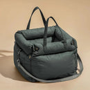 DreammyDoggie dark grey faux leather booster dog car seat with plush padding, carry handles, and adjustable safety straps.