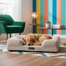 DreammyDoggie khaki sofa dog bed with a golden retriever sleeping on it in a colorful living room