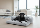 DreammyDoggie large grey faux fur sofa bed with a black Labrador resting comfortably in a modern living room.