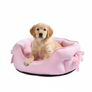 DreammyDoggie pink plush anti-anxiety princess dog bed with bow detail and a golden retriever puppy sitting inside