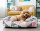 DreammyDoggie plush dog bed with a geometric pink and blue pattern, featuring a cozy grey interior for winter comfort.
