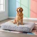 DreammyDoggie plush grey orthopedic dog bed with a golden retriever sitting on it in a colorful room