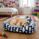 DreammyDoggie plush dog bed with blue whale pattern and grey interior, featuring a sleeping golden retriever.