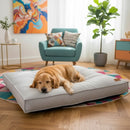 DreammyDoggie waterproof grey dog bed with a golden retriever sleeping on it in a bright, modern living room.